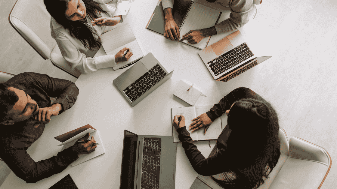 Office workers with latops having a meeting