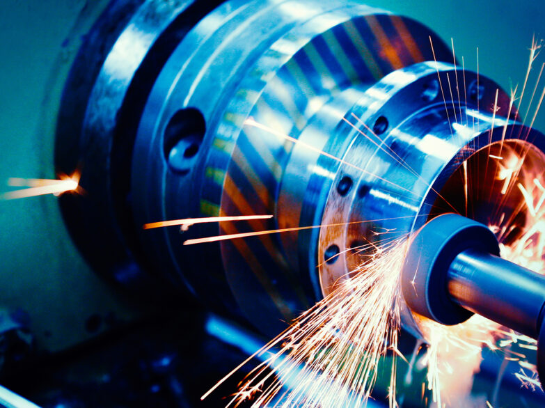 A machine emitting sparks, indicating active operation or welding, with bright flashes surrounding it.