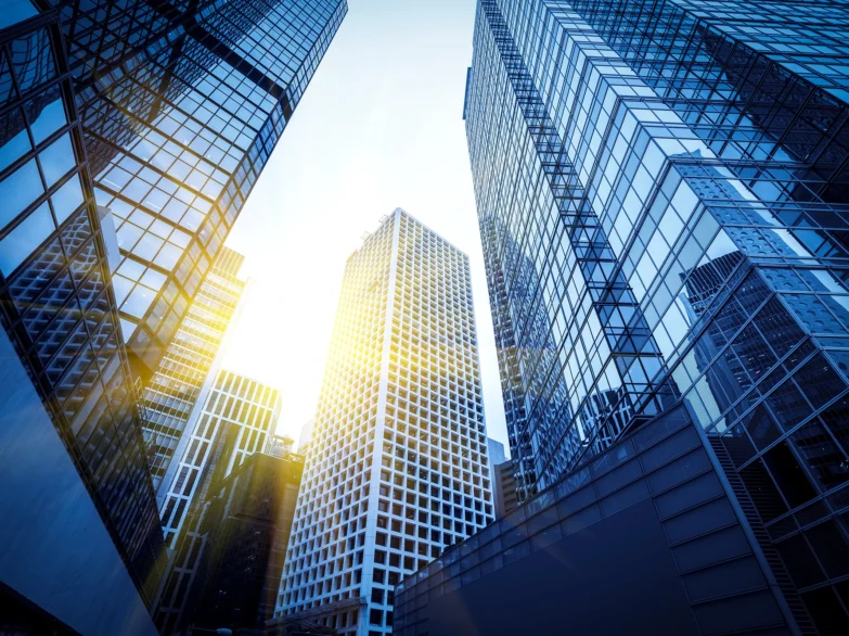 Tall glass offices with sunlight streaming through, creating a warm and vibrant urban scene.