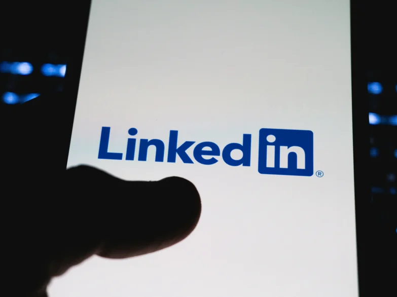 A close up of a mobile phone with Linkedin on the screen.