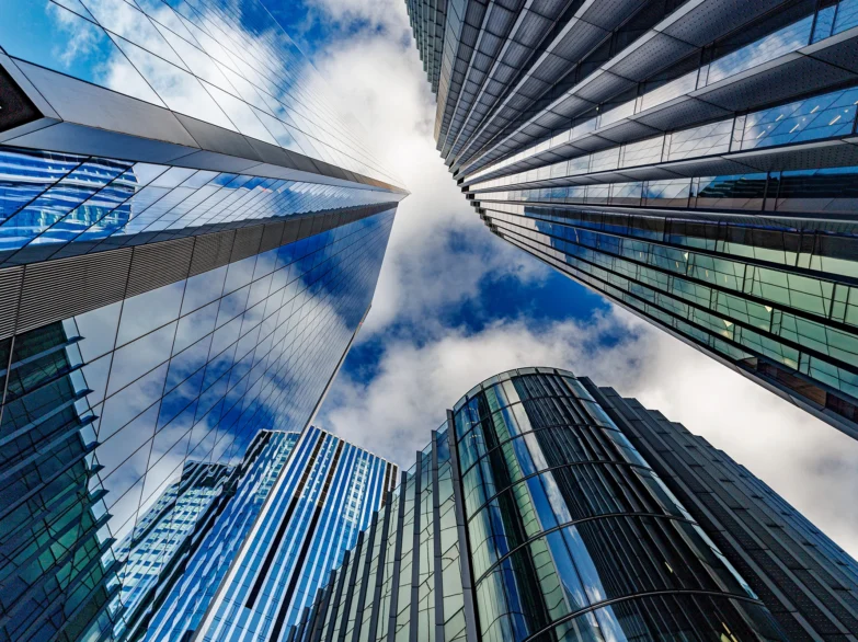 Skyscrapers towering against a bright blue sky, showcasing modern architecture and urban landscape.
