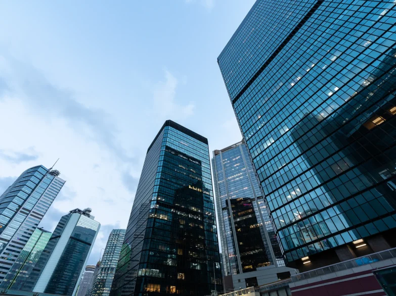 Tall buildings rise against a clear sky in a bustling cityscape, showcasing urban architecture.