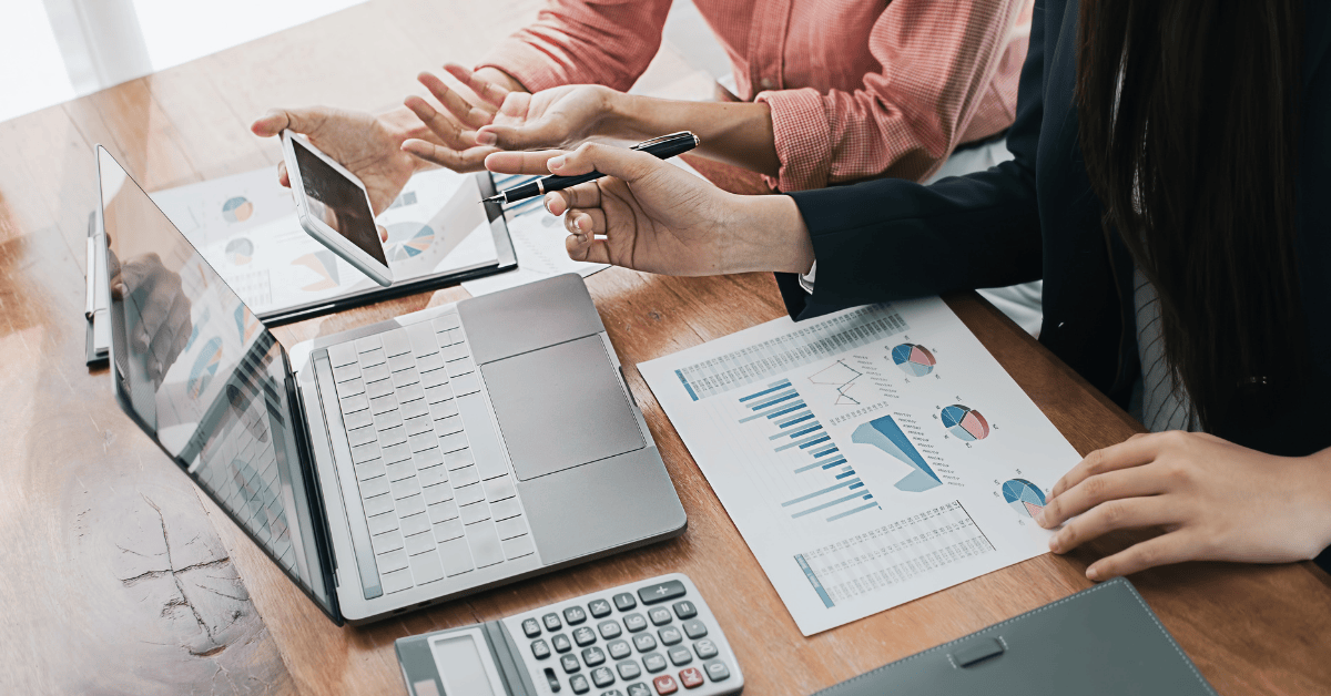 office workers sat around laptop